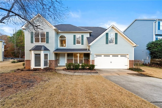 view of property featuring a front lawn and a garage