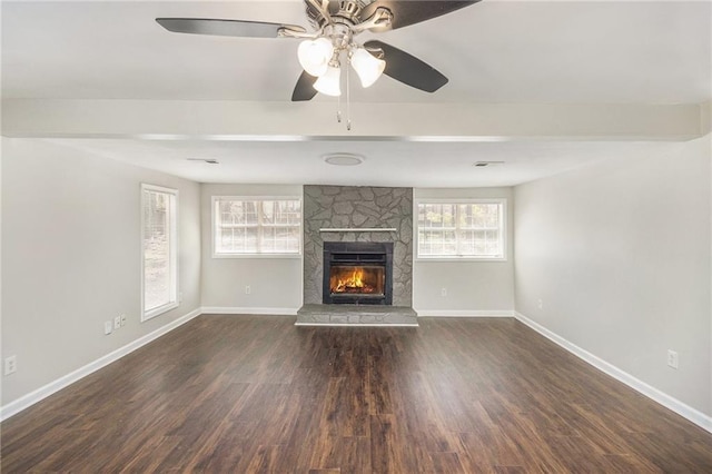 unfurnished living room with a fireplace, baseboards, dark wood-style floors, and ceiling fan