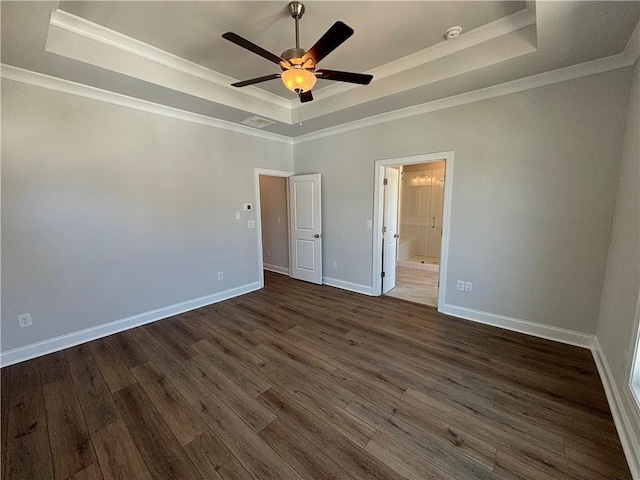 unfurnished bedroom with ceiling fan, dark hardwood / wood-style flooring, crown molding, and a tray ceiling