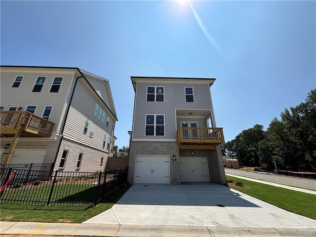 view of front of home with a balcony, a front yard, and a garage