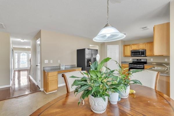dining room with baseboards and visible vents