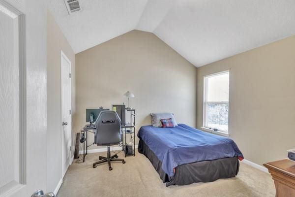 bedroom with vaulted ceiling, carpet floors, visible vents, and baseboards