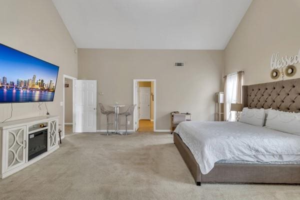 bedroom featuring carpet, baseboards, visible vents, and high vaulted ceiling