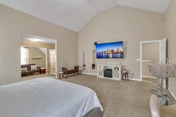 carpeted bedroom with high vaulted ceiling, baseboards, and a fireplace