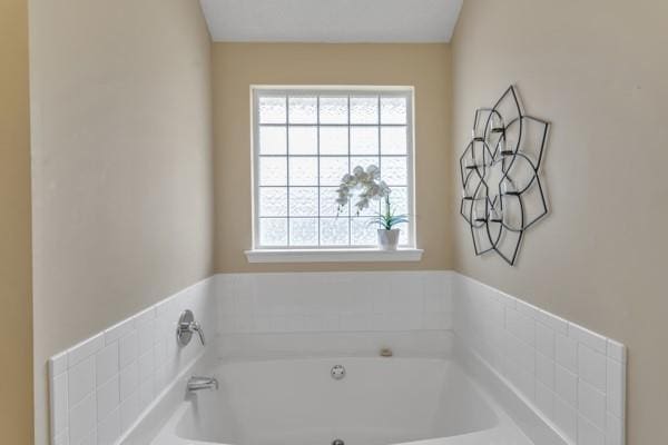 bathroom with a garden tub