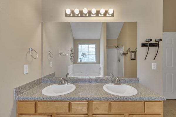 full bath featuring double vanity, a bath, a stall shower, and a sink