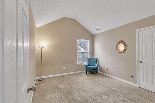living area featuring visible vents, baseboards, vaulted ceiling, and carpet flooring