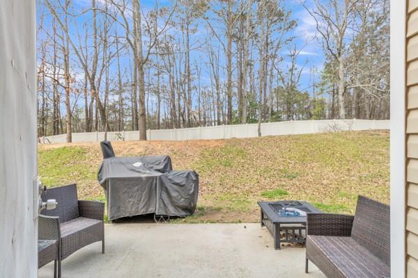 view of patio / terrace with a fire pit and a grill