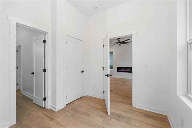 unfurnished living room featuring heating unit, a healthy amount of sunlight, and light hardwood / wood-style floors