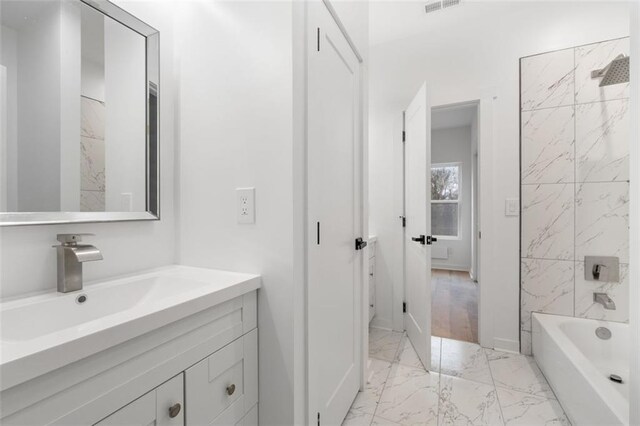 unfurnished bedroom with ceiling fan, multiple windows, light hardwood / wood-style flooring, and a closet