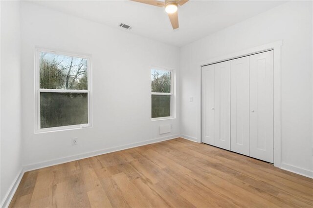 spare room featuring light wood-type flooring and ceiling fan