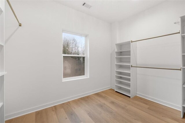 bathroom featuring independent shower and bath, hardwood / wood-style flooring, and vanity