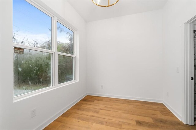 unfurnished living room featuring ceiling fan, heating unit, a healthy amount of sunlight, and light wood-type flooring