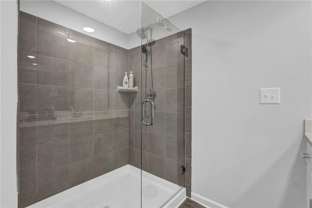 bathroom featuring baseboards and a stall shower