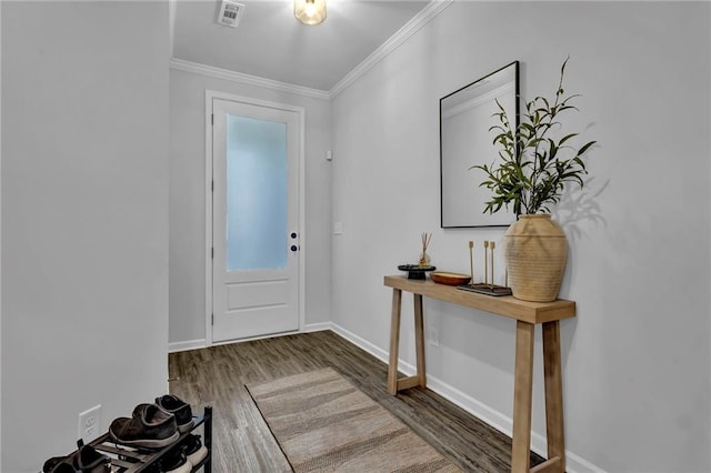 entrance foyer with crown molding, wood finished floors, visible vents, and baseboards