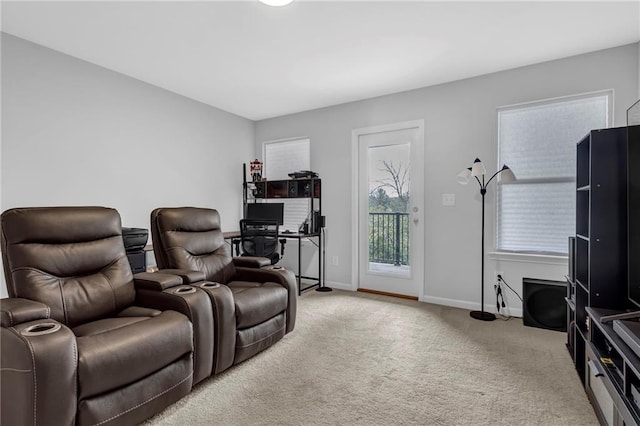 carpeted cinema room with baseboards