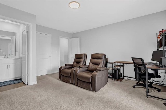 office area featuring a sink, baseboards, and carpet flooring