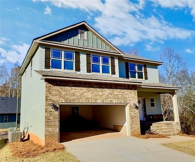 craftsman house with central AC unit, a porch, and a garage