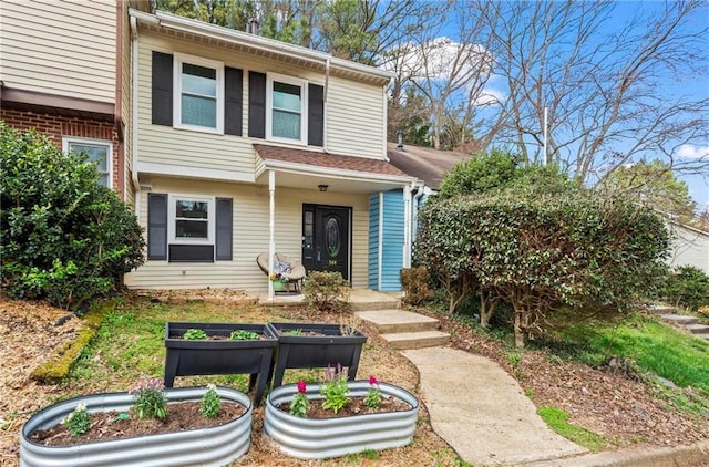 view of front of property with a garden