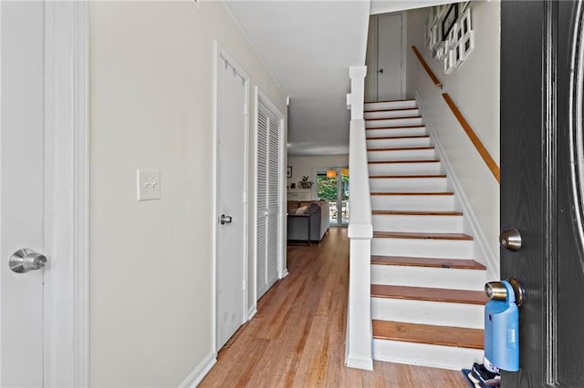 stairs featuring wood finished floors