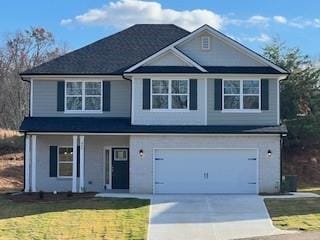 view of front property featuring a garage and a front yard