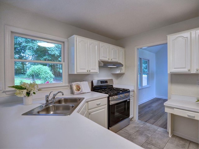 750 Whitehall Way, Roswell, GA 30076 - kitchen featuring stainless steel gas range oven, under cabinet range hood, white cabinets, and light countertops