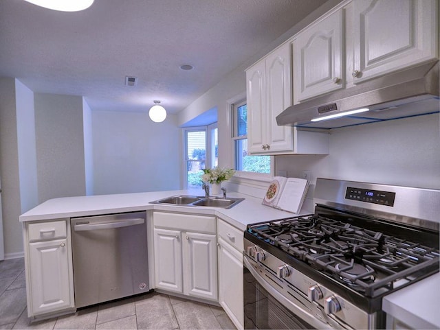 750 Whitehall Way, Roswell, GA 30076 - kitchen with stainless steel appliances, a peninsula, under cabinet range hood, white cabinets, and a textured ceiling
