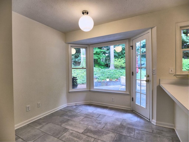750 Whitehall Way, Roswell, GA 30076 - unfurnished dining area featuring a textured ceiling and stone finish flooring