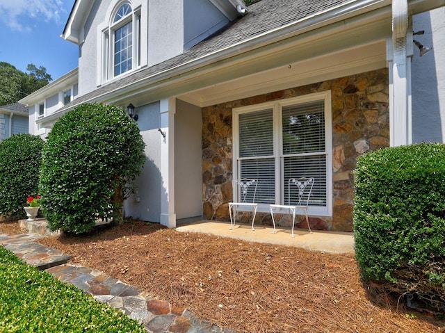 750 Whitehall Way, Roswell, GA 30076 - doorway to property featuring stone siding, stucco siding, and roof with shingles