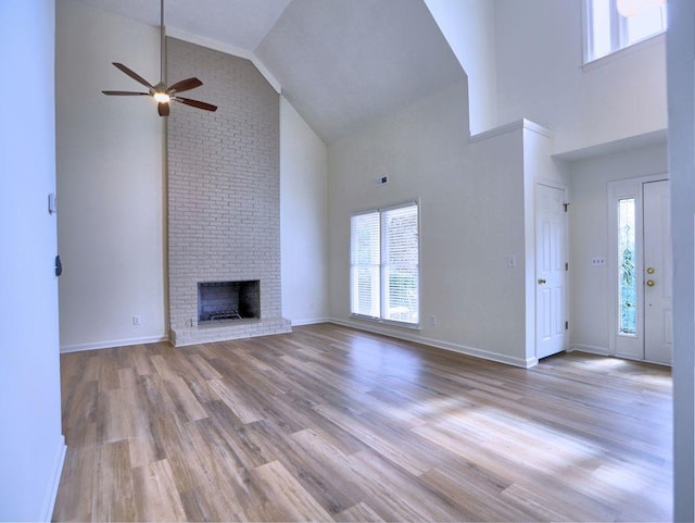 750 Whitehall Way, Roswell, GA 30076 - unfurnished living room featuring high vaulted ceiling, healthy amount of natural light, a ceiling fan, wood finished floors, and a brick fireplace