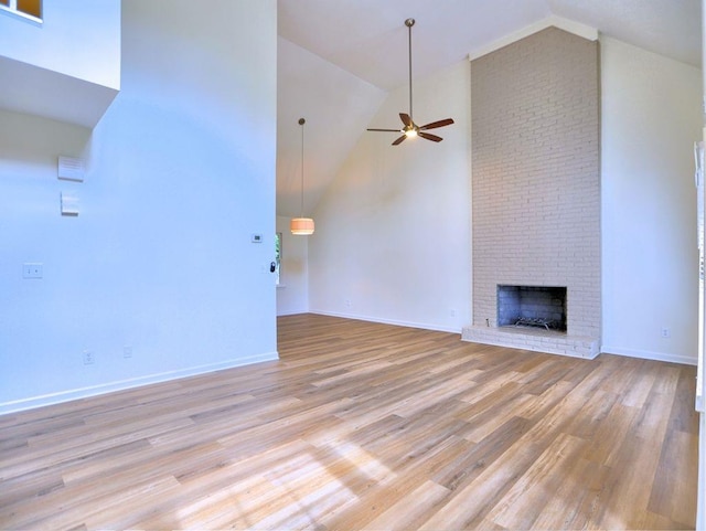750 Whitehall Way, Roswell, GA 30076 - unfurnished living room featuring ceiling fan, a brick fireplace, high vaulted ceiling, and light wood-type flooring
