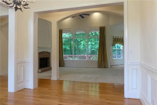 430 English Ivy Way, Woodstock, GA 30188 - hall with arched walkways, wood finished floors, and a chandelier