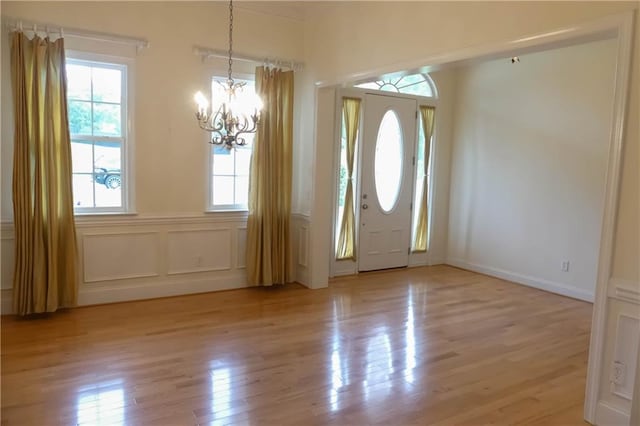 430 English Ivy Way, Woodstock, GA 30188 - entrance foyer featuring a chandelier, light wood-type flooring, a decorative wall, and wainscoting
