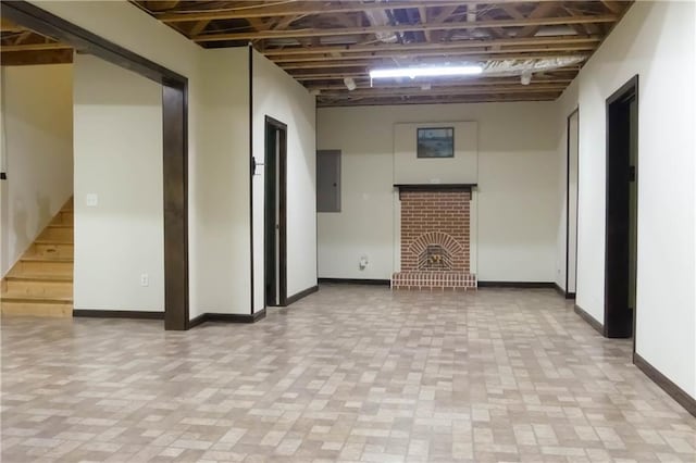 430 English Ivy Way, Woodstock, GA 30188 - basement with baseboards, brick patterned flooring, a fireplace, and electric panel