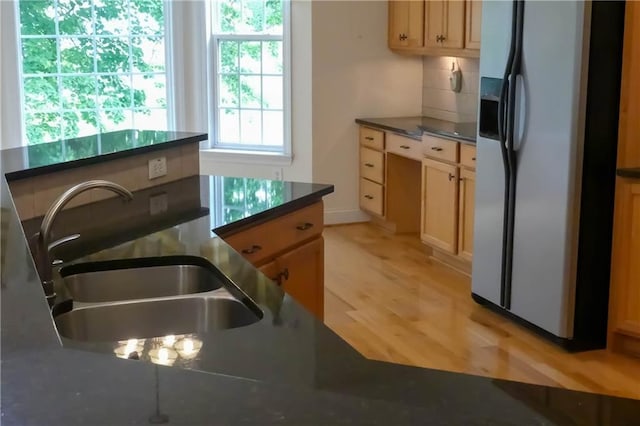 430 English Ivy Way, Woodstock, GA 30188 - kitchen featuring stainless steel fridge, a sink, dark countertops, light wood-style floors, and decorative backsplash