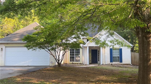 209 Southerness Ct, Stockbridge, GA 30281 - view of front of property with concrete driveway, fence, a garage, stucco siding, and roof with shingles