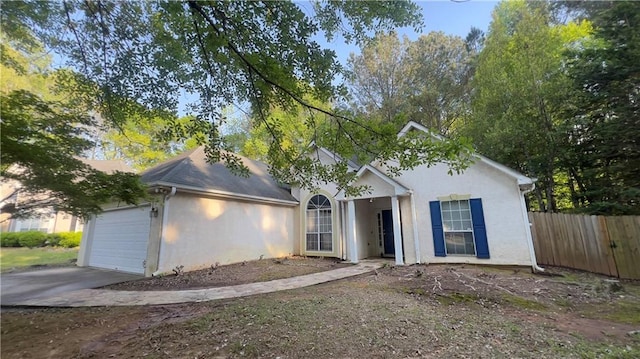 209 Southerness Ct, Stockbridge, GA 30281 - view of front of property featuring a garage, driveway, stucco siding, and fence