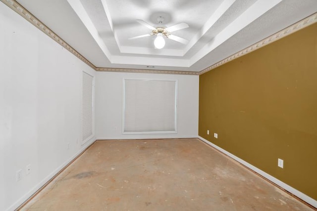 209 Southerness Ct, Stockbridge, GA 30281 - spare room with a tray ceiling, concrete floors, and a ceiling fan