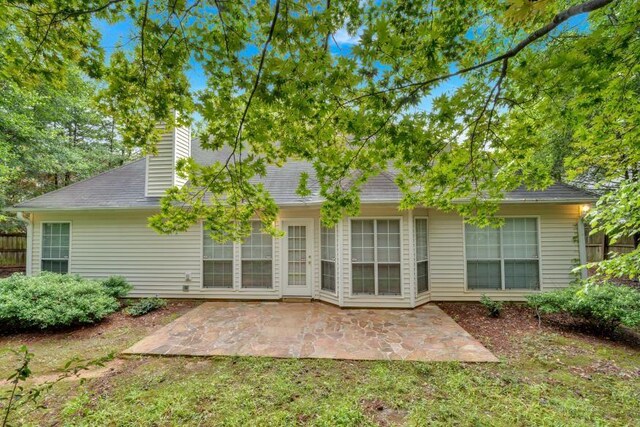 209 Southerness Ct, Stockbridge, GA 30281 - rear view of house with a patio area and a chimney