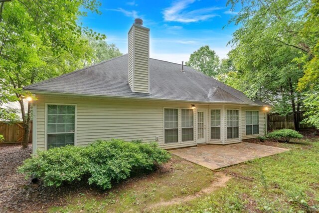 209 Southerness Ct, Stockbridge, GA 30281 - rear view of house with a patio area and a chimney