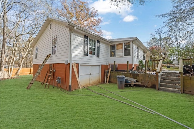 rear view of property featuring a lawn