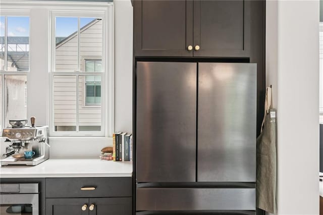kitchen with freestanding refrigerator, light countertops, and gray cabinets