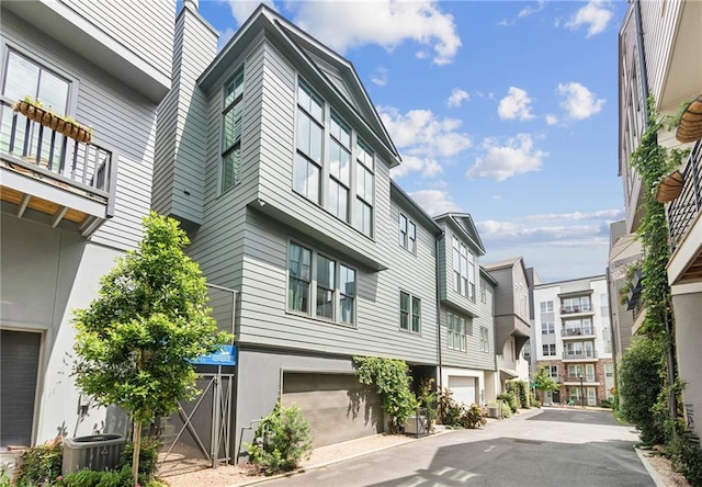 view of property featuring a residential view and an attached garage