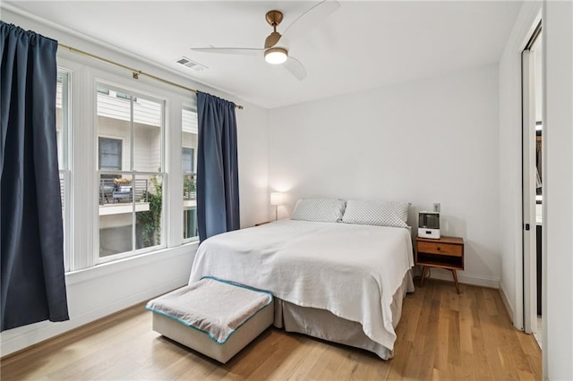 bedroom with light wood-style flooring and a ceiling fan
