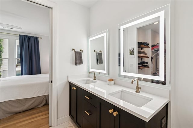 bathroom with double vanity and ensuite bathroom