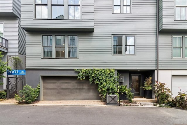 view of front of property featuring a garage and stucco siding