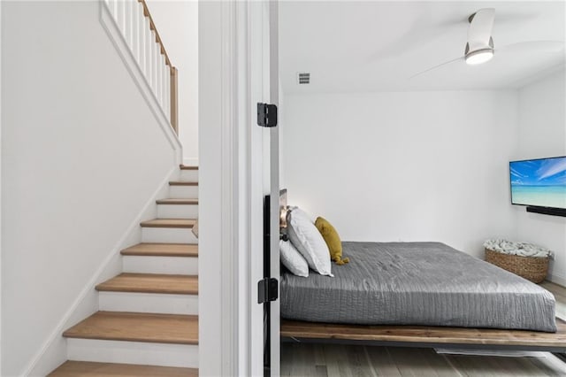 bedroom featuring wood finished floors and ceiling fan