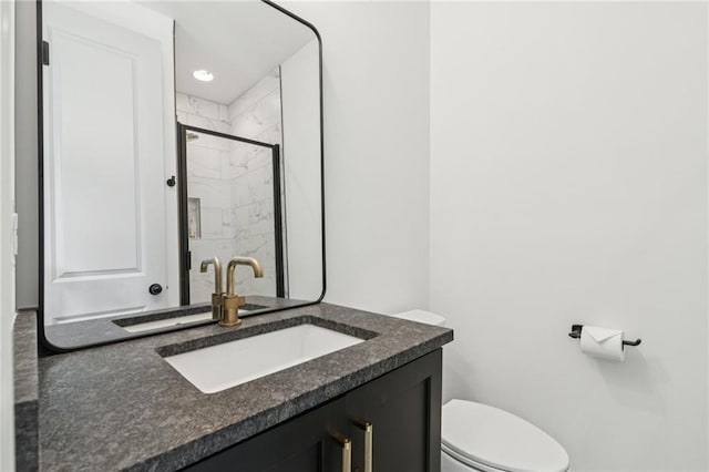 bathroom with a tile shower and vanity