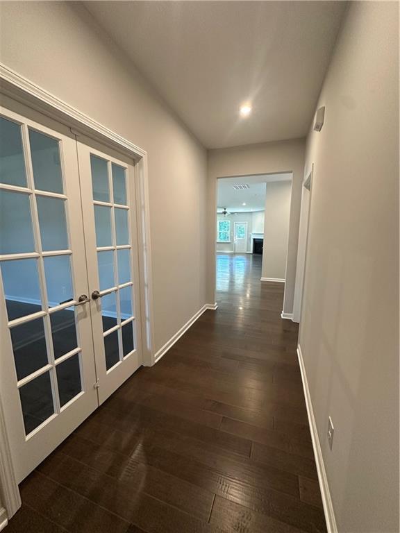861 Pineberry Ct, Grayson, GA 30017 - corridor with french doors, dark wood finished floors, and recessed lighting