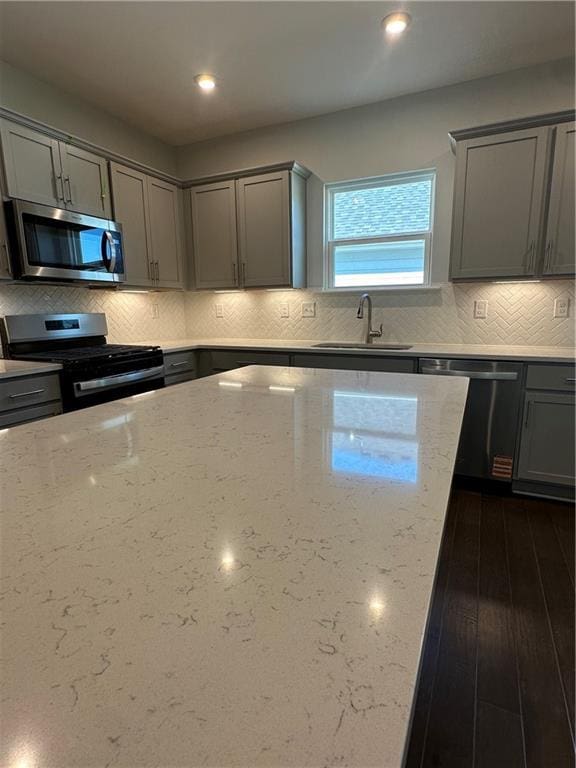 861 Pineberry Ct, Grayson, GA 30017 - kitchen featuring stainless steel appliances, gray cabinets, light stone countertops, decorative backsplash, and recessed lighting